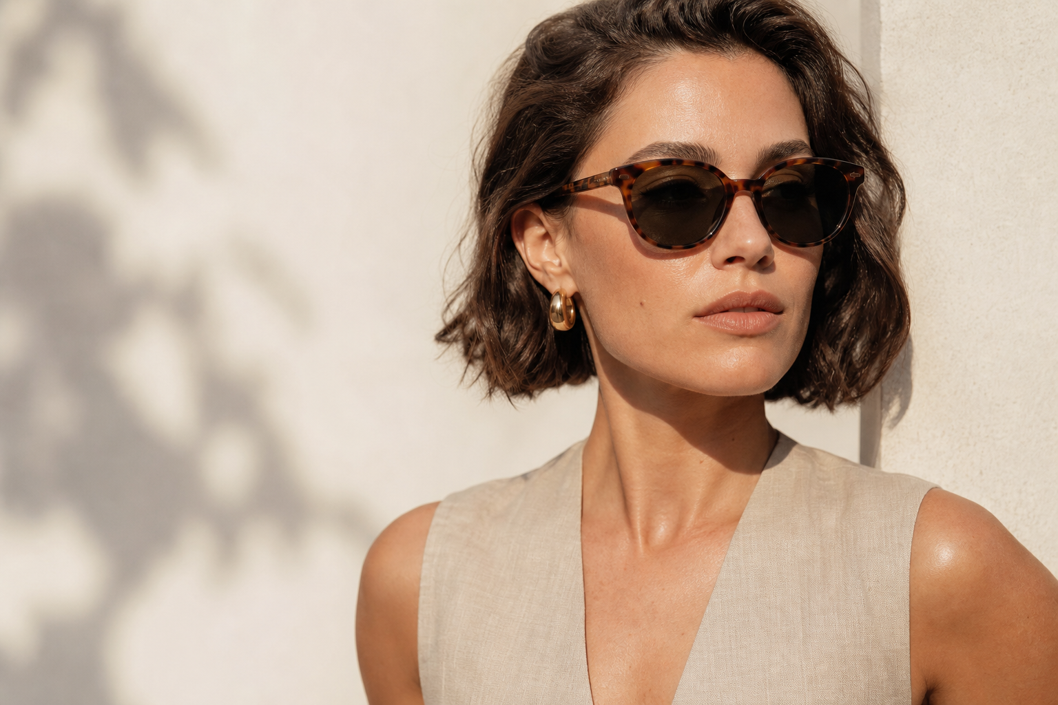 Woman wearing rounded tortoiseshell sunglasses for a best sunglasses for square face style guide